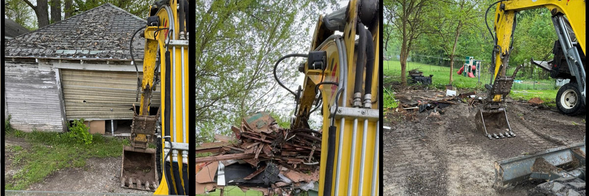 large machine tearing down old garage